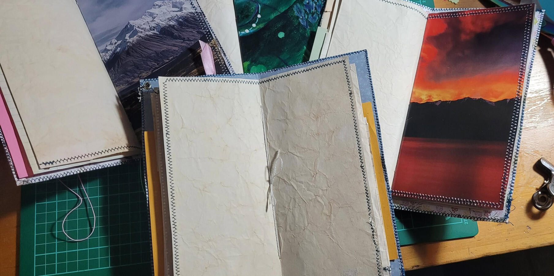 All of these traveller's journals have a full spread of coffee paper in the middle that is backed with a heavier image.